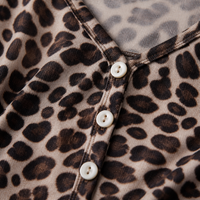 Close-up of the leopard print knit fabric and the V-neck button placket